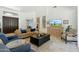 Spacious living room with high ceilings, comfortable seating, and a decorative cabinet with a large screen television at 7734 E Monica Dr, Scottsdale, AZ 85255
