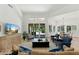 Bright and airy living room with plantation shutters, tile flooring, and views of the outdoor patio and landscaping at 7734 E Monica Dr, Scottsdale, AZ 85255