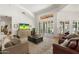 Bright and airy living room with a high ceiling, large windows, and a comfortable seating area for relaxation at 7734 E Monica Dr, Scottsdale, AZ 85255