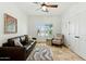 Cozy living room with comfortable seating, a ceiling fan, and natural light from the shuttered window at 7734 E Monica Dr, Scottsdale, AZ 85255
