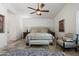 Main bedroom featuring tile floors, a ceiling fan, and a sitting area with a chair and bench at 7734 E Monica Dr, Scottsdale, AZ 85255
