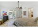 Spacious bedroom with neutral decor, a ceiling fan, shuttered windows, and travertine flooring at 7734 E Monica Dr, Scottsdale, AZ 85255