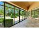 Enclosed patio with large windows offering a view of the backyard pool and landscaping at 7734 E Monica Dr, Scottsdale, AZ 85255
