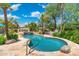 Beautiful pool with stone waterfall feature, lush landscaping, and plenty of room for lounging at 7734 E Monica Dr, Scottsdale, AZ 85255