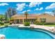 Close-up of a beautiful pool with a rock-lined edge, seamlessly connecting with the home's backyard patio at 7734 E Monica Dr, Scottsdale, AZ 85255