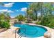 Custom pool and spa surrounded by lush landscaping on a sunny day at 7734 E Monica Dr, Scottsdale, AZ 85255