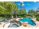 Backyard featuring a pool, spa and lush landscaping, perfect for entertaining at 7734 E Monica Dr, Scottsdale, AZ 85255