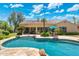Backyard pool with lush landscaping, a covered patio, and comfortable seating areas for outdoor relaxation at 7734 E Monica Dr, Scottsdale, AZ 85255