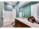 Stylish bathroom with blue accent wall, tub-shower combo, and modern vanity at 7854 W Tether Trl, Peoria, AZ 85383