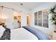 Bright bedroom featuring a barn door leading to a walk-in closet and stylish wall decor at 7854 W Tether Trl, Peoria, AZ 85383