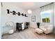 Charming Bedroom with a crib, soft chair, and playful decor at 7854 W Tether Trl, Peoria, AZ 85383
