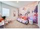Playful ' bedroom with whimsical unicorn-themed wallpaper and a teepee-style bed at 7854 W Tether Trl, Peoria, AZ 85383