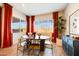 Bright dining room with a modern table, stylish chairs, and large windows with a view at 7854 W Tether Trl, Peoria, AZ 85383