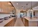 Spacious kitchen featuring stainless steel appliances, an island, and modern lighting fixtures at 7854 W Tether Trl, Peoria, AZ 85383