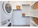Convenient laundry room featuring a stacked washer and dryer, and closet space for storage at 7854 W Tether Trl, Peoria, AZ 85383