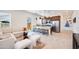 Cozy living room with an open kitchen, modern barstools, and comfortable seating area at 7854 W Tether Trl, Peoria, AZ 85383