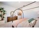 Serene main bedroom featuring a four-poster bed, wood dresser, and natural light at 7854 W Tether Trl, Peoria, AZ 85383