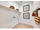 Well-organized mud room with shelves, hooks, and decorative wall art at 7854 W Tether Trl, Peoria, AZ 85383