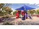 Community playground with slides, climbing structures, and shaded seating at 7854 W Tether Trl, Peoria, AZ 85383