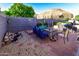 Inviting backyard patio with seating, a fire pit, and a tranquil water feature at 7916 E Naranja Ave, Mesa, AZ 85209