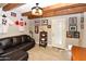 Finished basement featuring tile flooring, exposed beams, and a comfortable leather sofa at 7916 E Naranja Ave, Mesa, AZ 85209