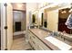 Bathroom with gray countertops, double mirrors, and a shower, offering ample space and functionality at 7916 E Naranja Ave, Mesa, AZ 85209