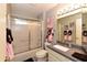 Cozy bathroom with a shower, vanity, and soft pink accents, creating a serene and inviting space at 7916 E Naranja Ave, Mesa, AZ 85209