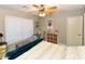 Bright bedroom featuring a ceiling fan, comfortable bed, desk, and ample storage space at 7916 E Naranja Ave, Mesa, AZ 85209