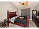Bedroom featuring a bed, ceiling fan, gray walls, and wood-look tile flooring at 7916 E Naranja Ave, Mesa, AZ 85209