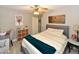 Charming bedroom featuring a ceiling fan, comfortable bed, desk, and ample storage at 7916 E Naranja Ave, Mesa, AZ 85209
