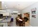 Cozy dining area open to kitchen and living area, featuring modern lighting at 7916 E Naranja Ave, Mesa, AZ 85209