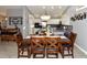 Inviting dining room with dark wood table and chairs, open to kitchen at 7916 E Naranja Ave, Mesa, AZ 85209