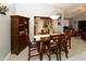 Dining room featuring a wooden table, six chairs, and a wine storage cabinet at 7916 E Naranja Ave, Mesa, AZ 85209