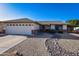 Charming single-story home featuring a low-maintenance landscape, complemented by neutral tones and a two-car garage at 7916 E Naranja Ave, Mesa, AZ 85209