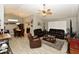 Spacious living room featuring tile flooring, neutral walls, and comfortable leather seating arrangement at 7916 E Naranja Ave, Mesa, AZ 85209