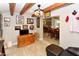 Inviting living room with wooden entertainment center, baseball bat, and open access to kitchen at 7916 E Naranja Ave, Mesa, AZ 85209