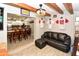 Cozy living room featuring a leather couch, wood beams, and decorative sports memorabilia at 7916 E Naranja Ave, Mesa, AZ 85209