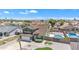 Lovely green two-story home featuring a pool, well-maintained yard, and lush landscaping in a serene neighborhood setting at 8871 W Maryland Ave, Glendale, AZ 85305