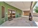 Covered back patio featuring exterior lighting and sliding glass doors at 8871 W Maryland Ave, Glendale, AZ 85305