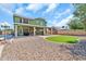 Expansive backyard featuring low-maintenance rock landscaping, green space, and a covered patio at 8871 W Maryland Ave, Glendale, AZ 85305