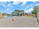 A spacious backyard offers a pool, rock landscaping, and a covered patio at 8871 W Maryland Ave, Glendale, AZ 85305