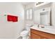 Half bath featuring a white vanity, neutral walls, and bright lighting at 8871 W Maryland Ave, Glendale, AZ 85305