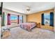 Spacious bedroom filled with natural light, featuring neutral carpet and large windows offering scenic views at 8871 W Maryland Ave, Glendale, AZ 85305