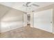 Neutral bedroom with a ceiling fan, closet, carpet, and access to the hallway at 8871 W Maryland Ave, Glendale, AZ 85305