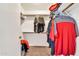 Walk-in closet with shelving and hanging rods for organized storage at 8871 W Maryland Ave, Glendale, AZ 85305