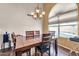 Inviting dining area with hardwood floors, elegant chandelier, and view of the pool at 8871 W Maryland Ave, Glendale, AZ 85305