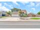 Charming two-story green home with a well-manicured front yard and white two-car garage at 8871 W Maryland Ave, Glendale, AZ 85305