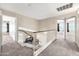 Spacious upstairs hallway leading to rooms with lots of natural light at 8871 W Maryland Ave, Glendale, AZ 85305