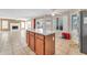 Spacious kitchen showcasing tiled floors, an island, and an open layout to the adjacent living area at 8871 W Maryland Ave, Glendale, AZ 85305
