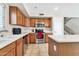 Bright kitchen features tile floors, stainless steel appliances, and an island for ample workspace at 8871 W Maryland Ave, Glendale, AZ 85305